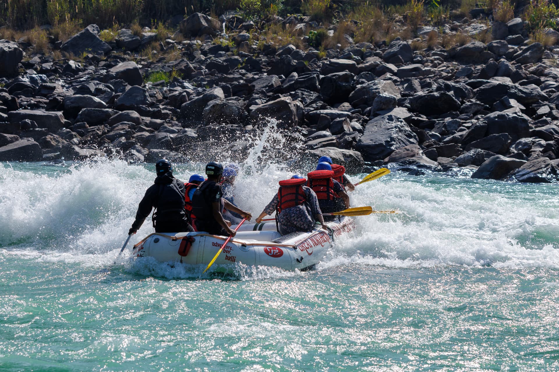 Raft punching through a big rapid on the Ganga